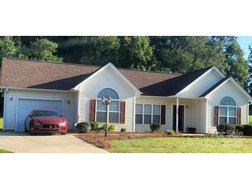 Charming single story home with brown roof, red shutters, lush lawn and a beautiful red vehicle in the driveway at 426 Summer Ridge Rd, Stanley, NC 28164