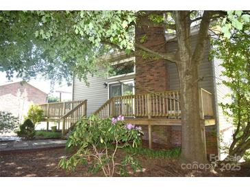 Cozy back deck with brick chimney and mature landscaping offers a serene outdoor living space at 5769 Birch St, Conover, NC 28613