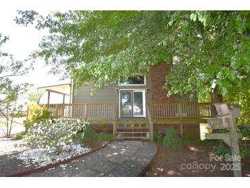 Charming home featuring a welcoming porch and beautiful landscaping, shaded by mature trees at 5769 Birch St, Conover, NC 28613