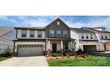 Charming two-story home with stone accents, attached garage and inviting front porch at 642 Amberjack Pl # 75, York, SC 29745