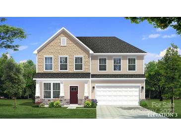 Charming two-story home featuring a two-car garage, inviting front porch, and beautifully landscaped front yard at 642 Amberjack Ln, York, SC 29745