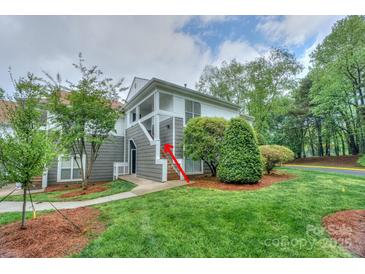 Inviting two-story condo featuring well-maintained landscaping, a charming exterior, and a private entrance at 765 Southwest Dr, Davidson, NC 28036