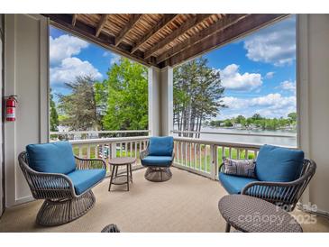 Inviting balcony with comfortable seating and scenic lake views, perfect for relaxing and entertaining at 7822 Village Harbor Dr, Cornelius, NC 28031