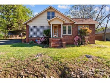 Charming brick home with mature landscaping and a covered parking area at 834 Murphy St, Kannapolis, NC 28081