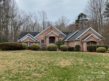 Charming single-story brick home with well-manicured landscaping and inviting curb appeal at 9113 Oak Bluff Ct, Waxhaw, NC 28173