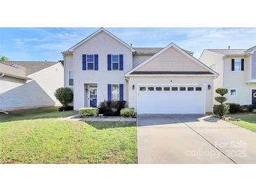 Charming two-story home featuring blue shutters, landscaped yard, and a two-car garage at 17546 Westmill Ln, Charlotte, NC 28277