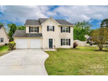 Charming two-story home with a two-car garage, well-maintained lawn, and a classic design at 225 Carrie Ct, Concord, NC 28027