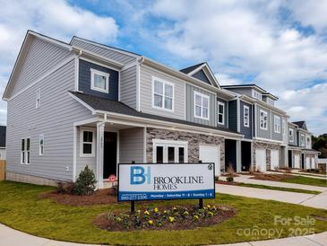 Attractive townhome exteriors feature stone accents, inviting entrances, and well-manicured lawns at 2555 Ruby Dixon Crossing Dr # 16, Gastonia, NC 28056