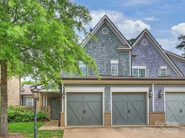 Charming home featuring a two-car garage, and shingle siding, set in a lush, landscaped neighborhood at 2616 Colton Dr, Charlotte, NC 28211