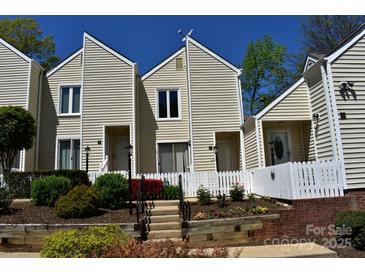 Charming townhome with a white picket fence and well-maintained landscaping at 331 Eastwood Dr, Salisbury, NC 28146