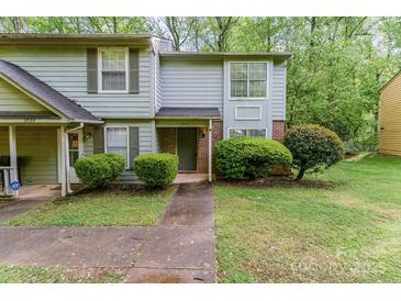 Charming two-story townhome featuring tidy landscaping and a welcoming entrance at 3941 Briarhill Dr, Charlotte, NC 28215