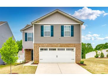 Charming two-story home featuring a brick facade, gray siding, blue shutters, and a pristine white garage door at 5014 Fandango Rd, York, SC 29745