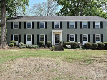 Charming brick home with black shutters, manicured landscaping, and inviting entrance at 557 Wakefield Dr # A, Charlotte, NC 28209