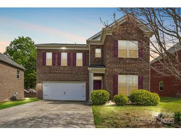 Beautiful two-story brick home with a two-car garage and manicured lawn at 620 Millstream Dr, Rock Hill, SC 29732