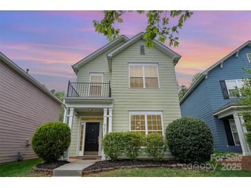 Charming two-story home featuring a small balcony, manicured shrubs, and a welcoming front entrance at 6707 Dunton St, Huntersville, NC 28078