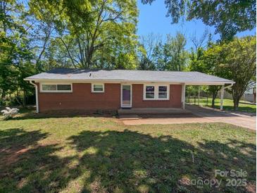 Charming one-story brick home with a well-maintained lawn and covered parking, perfect for easy access at 805 Mark Dr, Shelby, NC 28152