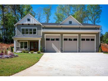 Charming home featuring a three-car garage and well-maintained lawn at 139 Poplar Grove Rd, Mooresville, NC 28117