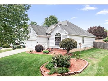 Charming single-story home with manicured lawn, beautiful landscaping and lovely curb appeal at 141 Rose St, Mooresville, NC 28117