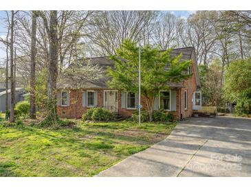Charming brick home featuring a well-maintained lawn, mature trees, and inviting curb appeal at 1620 Edgefield Ave, Gastonia, NC 28052