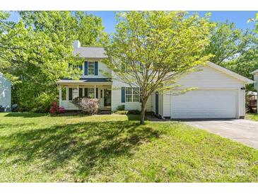 Charming two-story home with a well-manicured lawn, attached garage, and welcoming front porch at 1694 Trotters Ridge Rd, Stanfield, NC 28163
