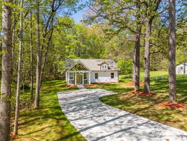 Charming home with a long driveway and lush greenery at 208 Spinners Dr, Cherryville, NC 28021
