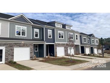 New townhomes with stone accents, garages, modern windows, and professional landscaping at 2579 Ruby Dixon Crossing Dr # 12, Gastonia, NC 28056