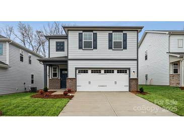 Charming two-story home with a two-car garage, blue shutters, and brick accents on the facade at 282 Bezelle Ave, York, SC 29745