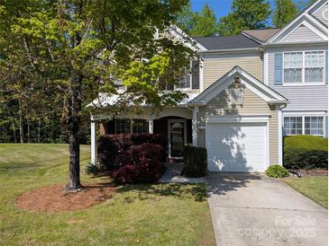 Charming home with an attached garage, a porch, and well-maintained landscaping at 6846 Beverly Springs Dr, Charlotte, NC 28270