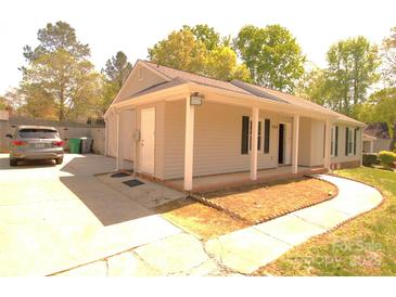 Charming single-story home featuring a welcoming front porch and well-maintained landscaping at 7428 Beaufort Cir, Charlotte, NC 28227