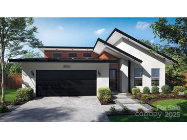 Modern home with a two-car garage, sleek black accents, and beautifully landscaped front yard at 8038 Pawtuckett Rd, Charlotte, NC 28214