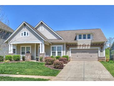 Charming single-Gathering home with a two-car garage, well-manicured lawn, and inviting front porch at 10378 Ambercrest Nw Ct, Huntersville, NC 28078