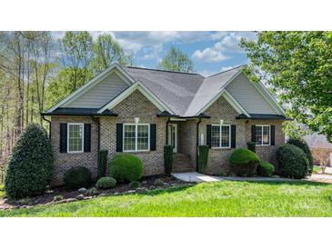 Charming brick home with manicured lawn, tasteful landscaping, and classic architectural details at 1158 Waterford Dr, Hickory, NC 28602