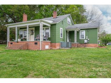 Charming green home with a welcoming front porch and well-maintained lawn at 211 Hershel Lackey Rd, Lincolnton, NC 28092
