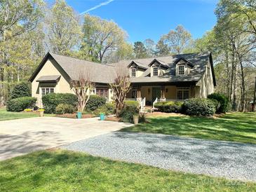 Charming home featuring manicured landscaping, dormer windows and a welcoming front porch perfect for relaxing at 4925 Pageland Hwy, Monroe, NC 28112