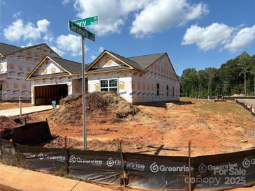 New construction home with visible protective wrap on exterior and yard under construction at 5602 Skinny Dr, Charlotte, NC 28215