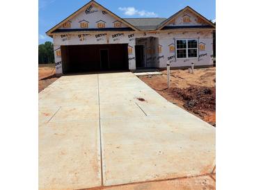 Unfinished home with a large driveway and two-car garage, awaiting personalization at 5602 Skinny Dr, Charlotte, NC 28215