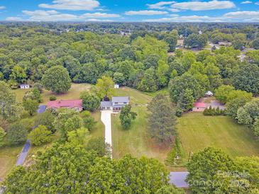Expansive aerial view of property surrounded by lush greenery and a long driveway leading to the home at 915 Gate Rd, Monroe, NC 28112