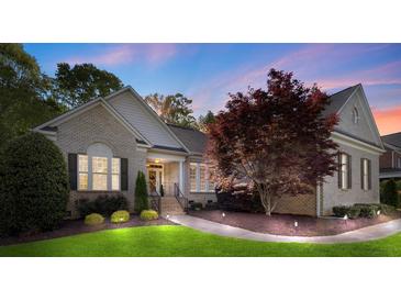 Charming brick home featuring manicured landscaping and a welcoming entrance, with a beautiful tree in the front yard at 1317 Waynewood Dr, Waxhaw, NC 28173