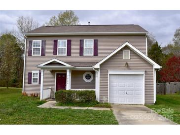 Charming two-story home with neutral siding, purple shutters, and a well-manicured front lawn at 14608 Arlandes Dr, Charlotte, NC 28278