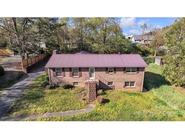 Charming brick home with a metal roof and well-manicured front lawn at 165 Northwest Rd, Hickory, NC 28601