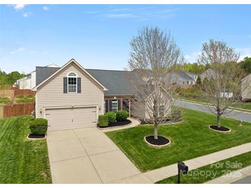 Charming home featuring a well-manicured lawn, a two-car garage, and classic suburban appeal at 2077 Taney Way, Fort Mill, SC 29707