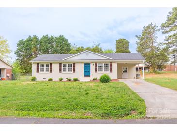 Charming single-story home with a bright blue front door and well-maintained lawn at 212 Pine St, Rockwell, NC 28138