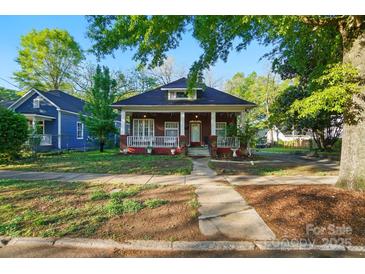 Charming brick bungalow with a covered front porch and mature trees in a walkable neighborhood at 247 W Park Ave, Charlotte, NC 28203