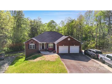 Charming brick home featuring an attached two-car garage and a well-manicured lawn at 3232 47Th Avenue Ne Pl, Hickory, NC 28601