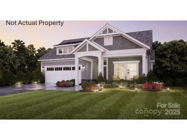 Charming two-story home with landscaped yard and gray siding; well manicured lawn at 46 Five Creek Rd # 46, Charlotte, NC 28213