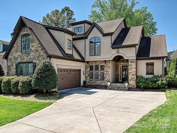 Charming two-story home featuring a stone and stucco facade, well-manicured landscaping, and a spacious driveway at 7208 Ashton Gate Dr, Charlotte, NC 28270