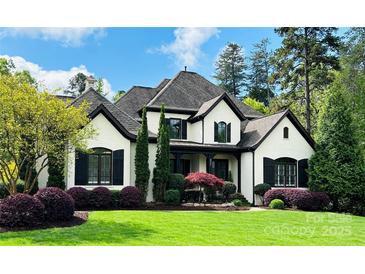 Charming two-story home with a landscaped yard and a classic white facade with black trim at 887 Harvest Pointe Dr, Fort Mill, SC 29708