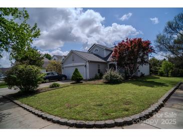 Charming home featuring manicured front lawn and a beautiful red maple tree enhancing its curb appeal at 10202 Orchard Grass Ct, Charlotte, NC 28278