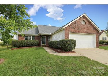Charming single-story brick home featuring a well-manicured lawn and an attached two-car garage at 11623 Black Maple Ave, Charlotte, NC 28269