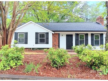 Charming single-story home with black shutters, a black door, and brick accents at 11817 Five Cedars Rd, Charlotte, NC 28226